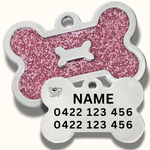 Pink glittery bone-shaped pet tag with black engraved text