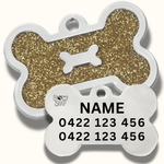 Dog tag with bone shape, gold glitter background, and engraved text 
